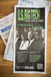 A close up image of a print version of the Toronto Star layed out on a tabletop. Featured prominently is the full-page ad ran by C4DS that reads "U.S. Big Tech rules our internet. On Canada Day, it's time to take back control.